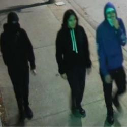 Image of three suspects wearing two black hoodies and one purple hoodie